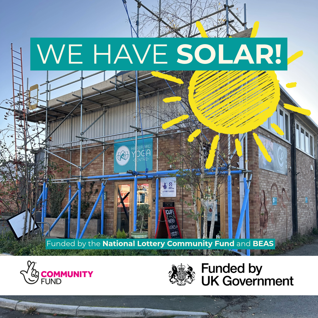 Front of Hereford Yoga Centre building with scaffolding as solar panels installed. Blue sunny winter sky, 