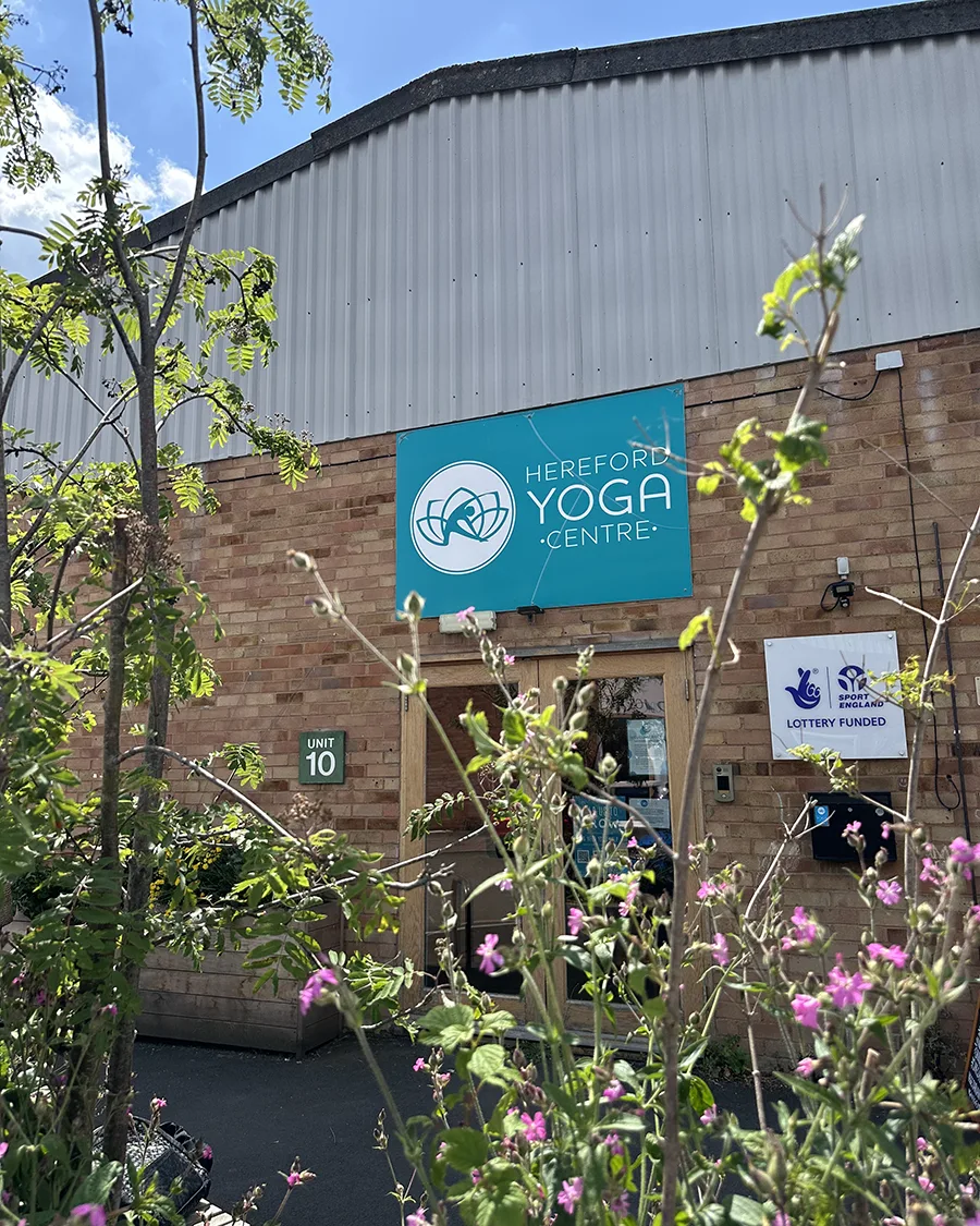 Hereford Yoga Centre building surrounded by seasonal planting in the shared community garden.